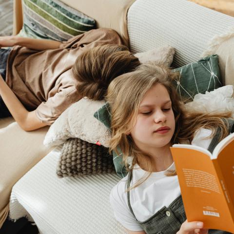 Siblings Lying on the Couch