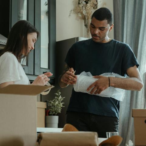 Couple packing to move house