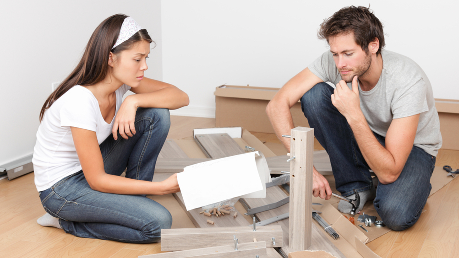 Couple assembling flat pack furniture