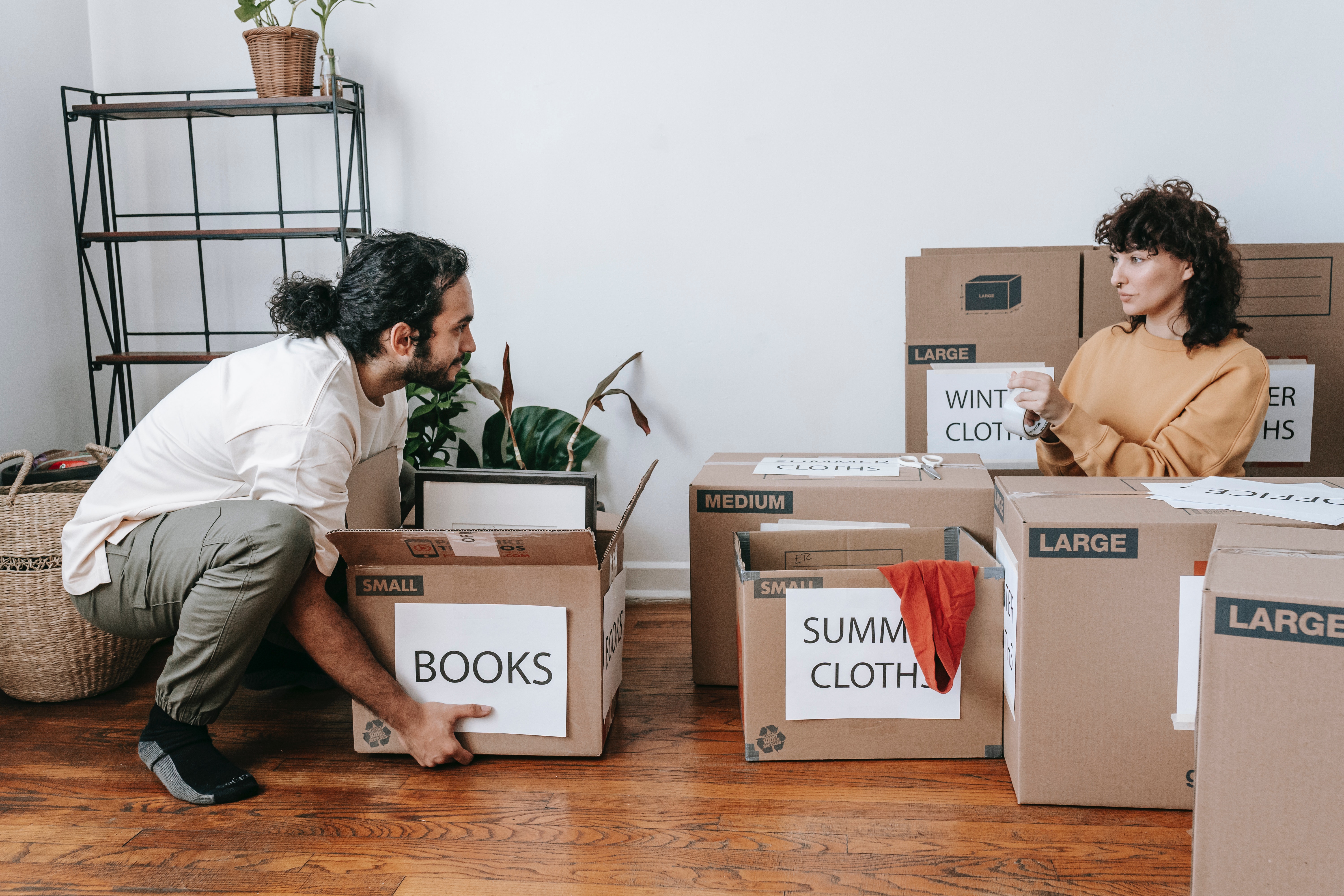 Couple packing up boxes with labels