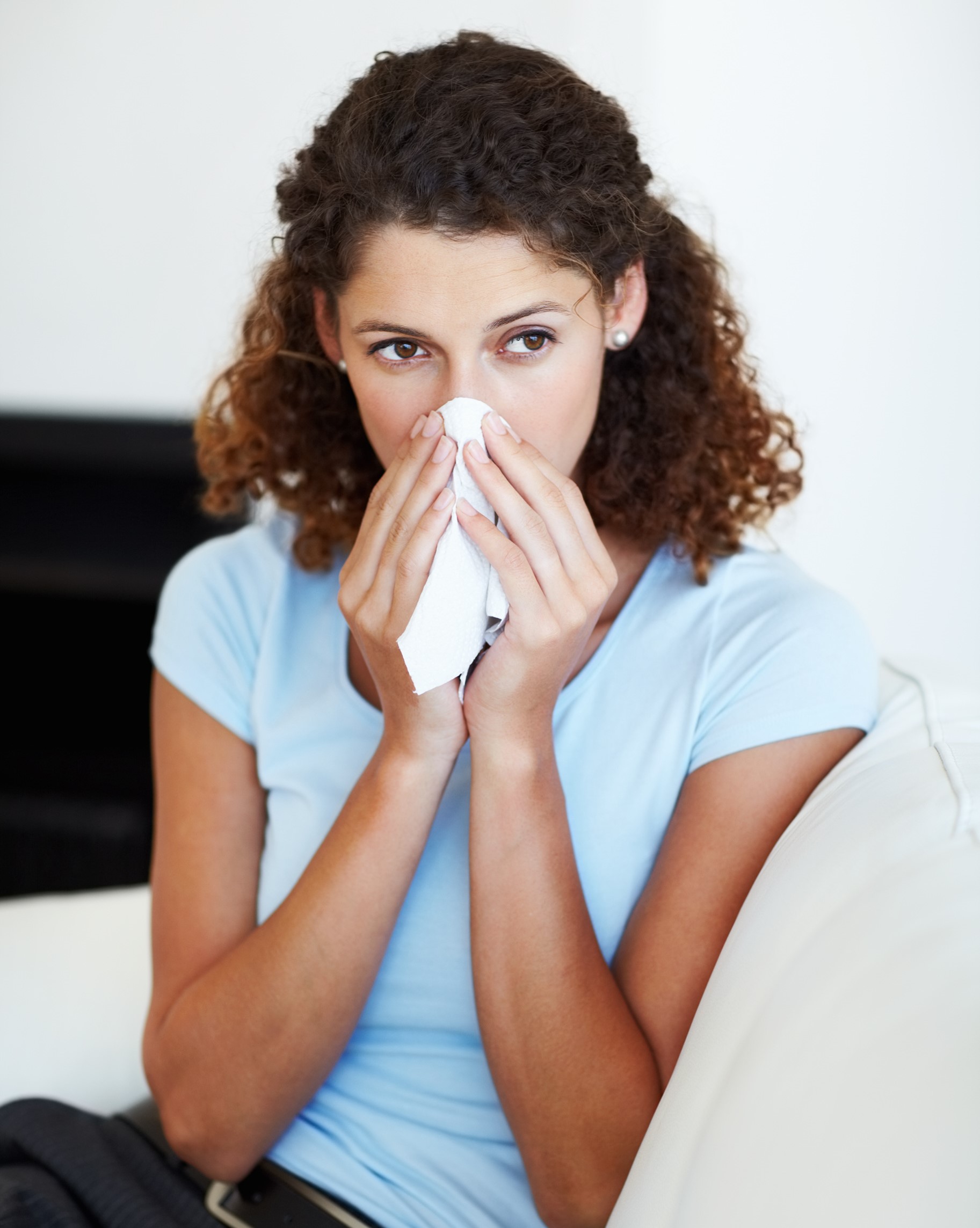 Woman blowing her nose