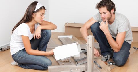 Couple assembling flat pack furniture