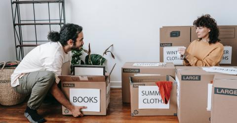 Couple packing up boxes with labels