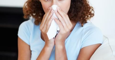 Woman blowing her nose